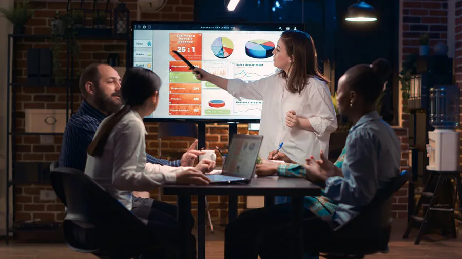 Digital Media 360 team discussing SEO and marketing strategy using data visualizations